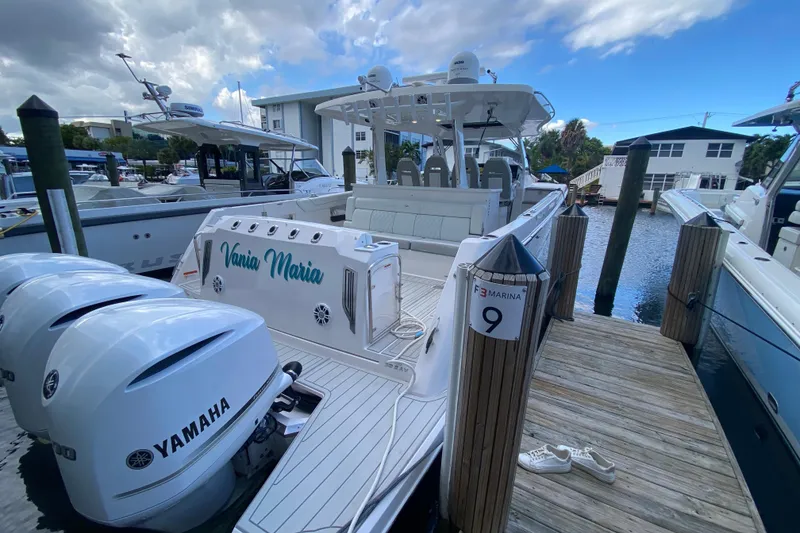 Slide: The Image of 2021 Regal 38 SAV boat docked at marina with Yamaha engines. - 40
