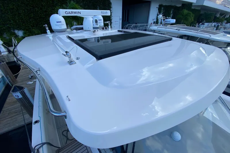 Slide: The Image of 2021 Regal 38 SAV yacht with Garmin radar and sleek white design. - 43