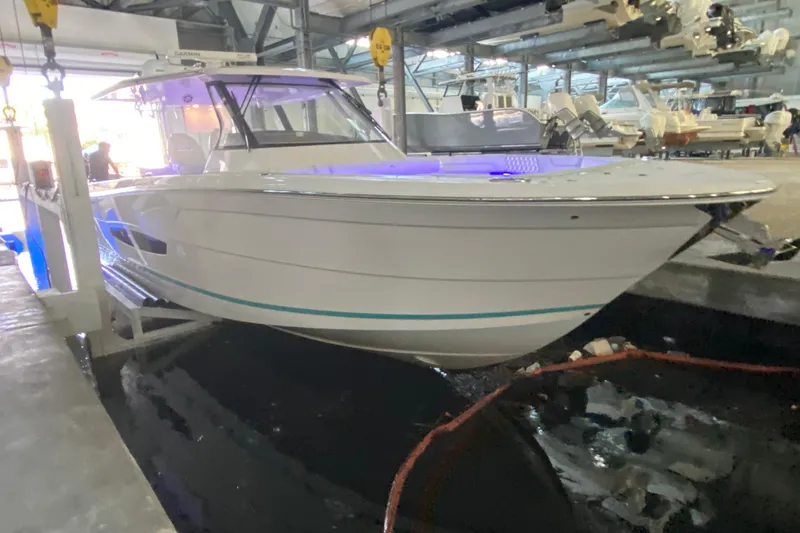 Slide: The Image of 2021 Regal 38 SAV boat in a marina, illuminated with blue lights. - 7