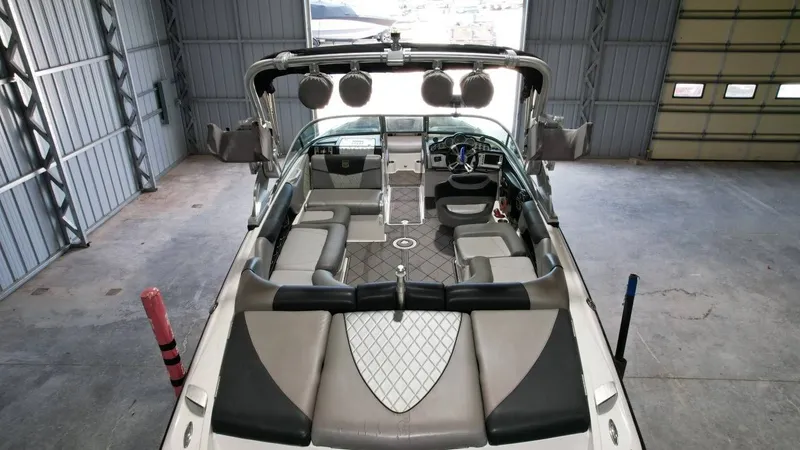 Slide: The Image of Interior view of a 2013 MasterCraft X-35 boat in a garage. - 17