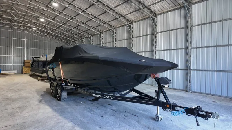 Slide: The Image of 2013 MasterCraft X-35 boat in storage on trailer. - 19