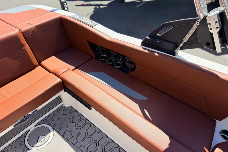 Slide: The Image of 2023 MasterCraft NXT23 boat interior with brown seating and modern design elements. - 14
