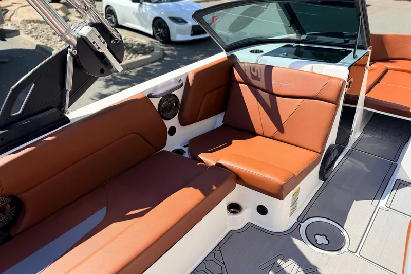 Slide: The Image of 2023 MasterCraft NXT23 boat interior with brown leather seating and modern design. - 15