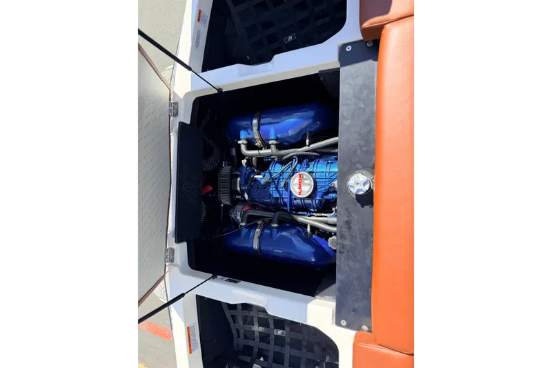 Slide: The Image of 2023 MasterCraft NXT23 boat engine, featuring a powerful Ilmor motor in a sleek compartment. - 22