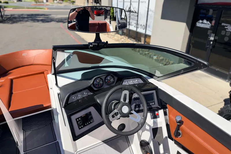 Slide: The Image of 2023 MasterCraft NXT23 boat cockpit with modern steering and dashboard controls. - 9