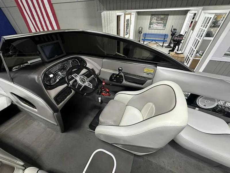 Slide: The Image of Interior of a 2005 Malibu Wakesetter VLX 21 boat with steering console. - 9