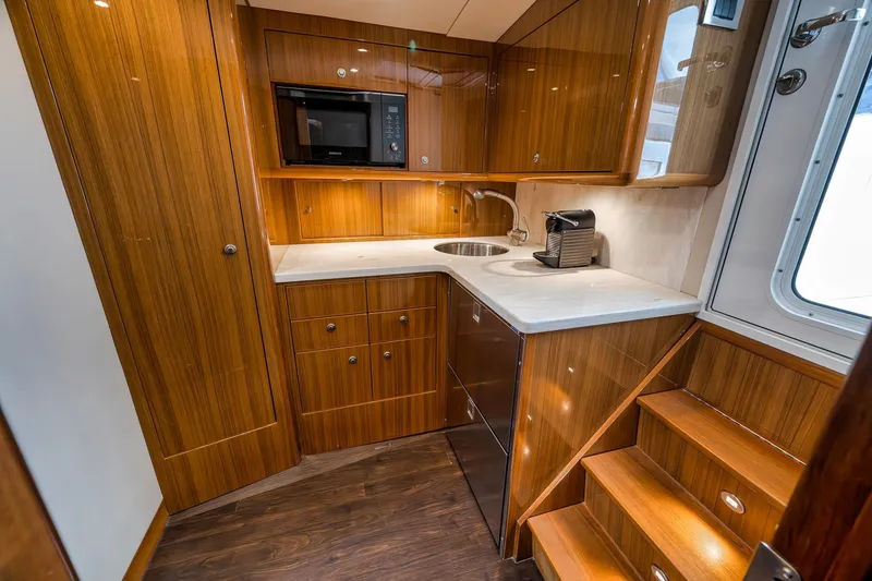 Slide: The Image of Luxurious 2018 Viking 37 Billfish yacht interior with modern kitchen and wooden cabinetry. - 22