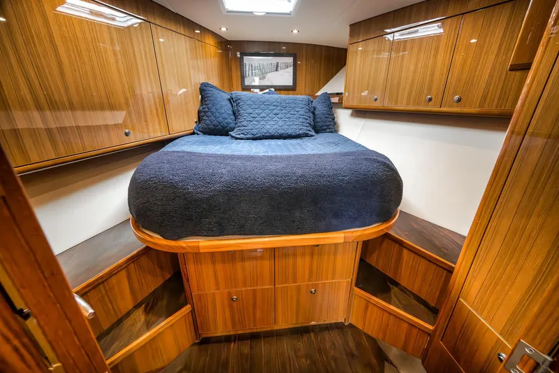 Slide: The Image of Luxurious cabin interior of 2018 Viking 37 Billfish with wood finish and cozy bedding. - 24