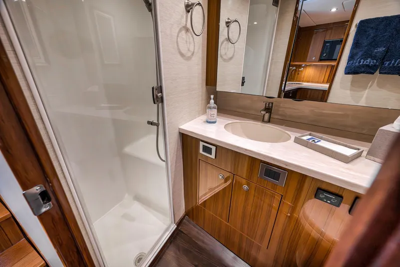 Slide: The Image of Luxurious bathroom in 2018 Viking 37 Billfish yacht with modern fixtures and wooden cabinetry. - 26