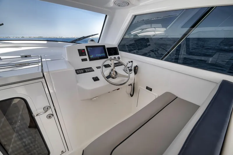 Slide: The Image of Helm of 2018 Viking 37 Billfish yacht with modern controls and ocean view. - 33