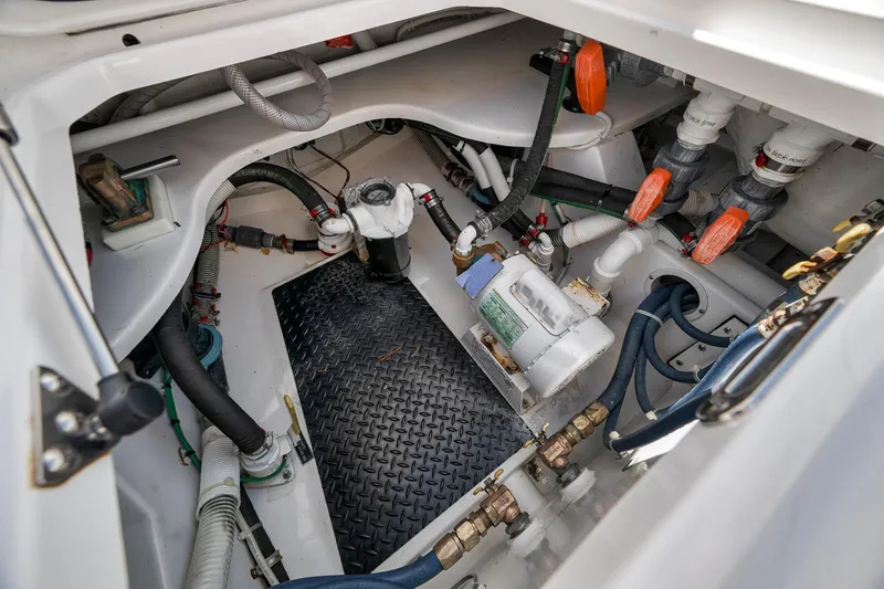 Slide: The Image of Engine compartment of 2018 Viking 37 Billfish boat, showcasing mechanical components and piping. - 46