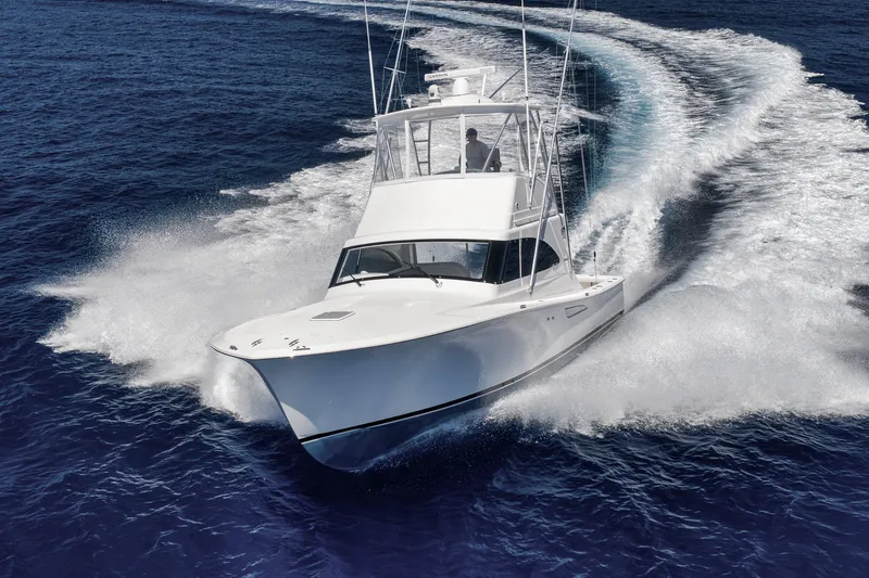 Slide: The Image of 2018 Viking 37 Billfish cruising on open ocean with city skyline in background. - 5