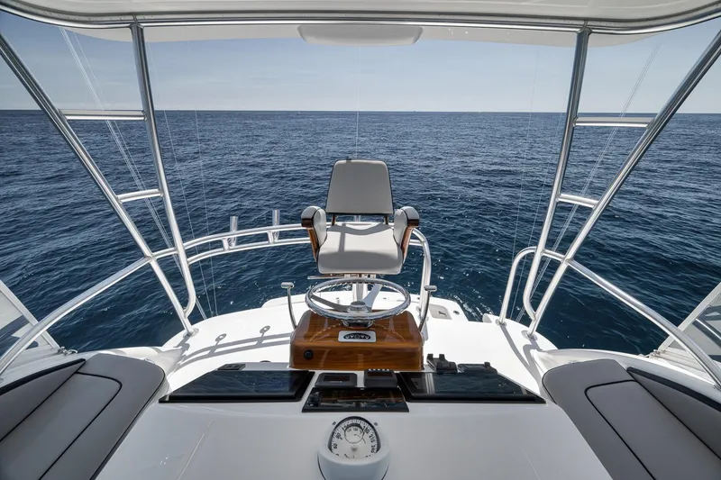 Slide: The Image of 2018 Viking 37 Billfish helm overlooking the ocean, featuring a captain's chair and navigation instruments. - 54