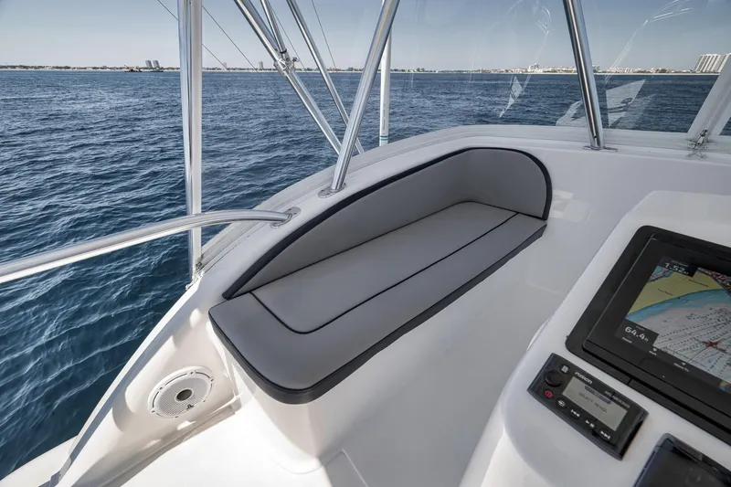 Slide: The Image of 2018 Viking 37 Billfish boat interior with seating and navigation display on open water. - 58