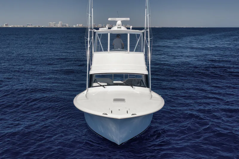 Slide: The Image of 2018 Viking 37 Billfish yacht cruising on open ocean with city skyline in background. - 9