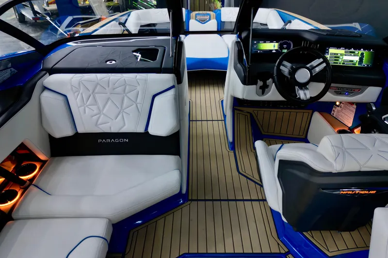 Slide: The Image of Interior of 2022 Nautique Super Air Nautique G25 Paragon boat with luxurious seating and modern dashboard. - 13