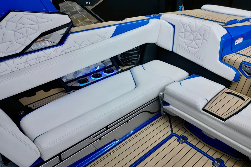Slide: The Image of 2022 Nautique Super Air Nautique G25 Paragon interior with luxurious seating and blue accents. - 17