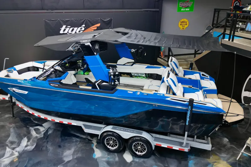 Slide: The Image of 2022 Nautique Super Air Nautique G25 Paragon boat on trailer, blue and white design. - 24