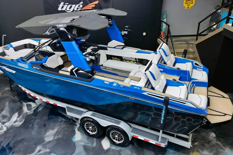Slide: The Image of 2022 Nautique Super Air Nautique G25 Paragon boat on trailer, blue and white design. - 7