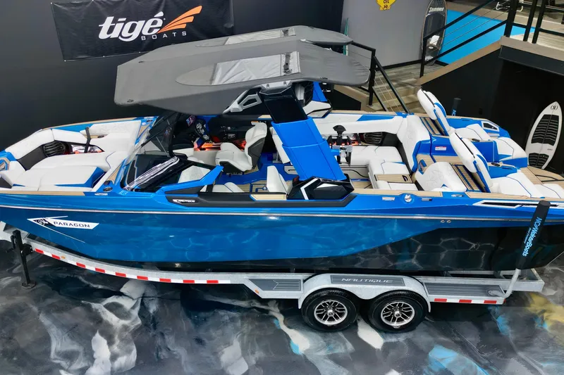 Slide: The Image of 2022 Nautique Super Air Nautique G25 Paragon boat on trailer, displayed indoors. - 8