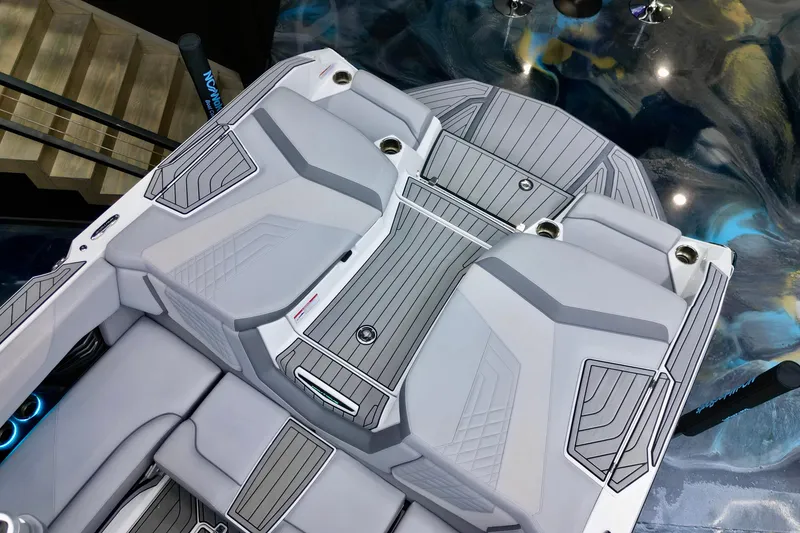 Slide: The Image of 2024 Nautique Super Air Nautique G23 boat interior with sleek gray seating and modern design. - 11