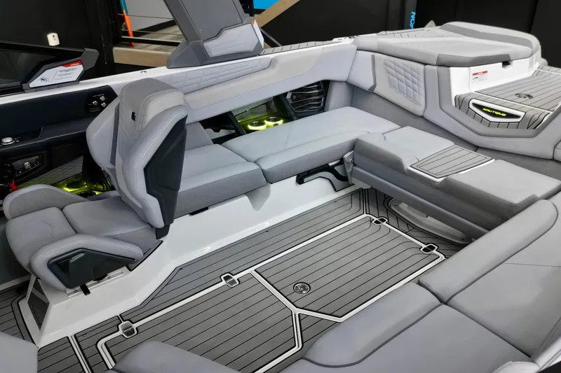 Slide: The Image of 2024 Nautique Super Air Nautique G23 interior with luxurious gray seating and modern design. - 13