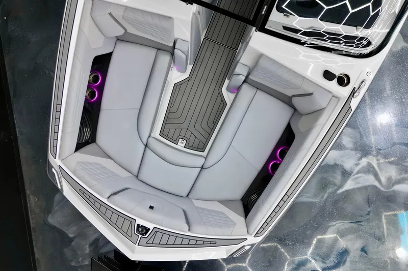Slide: The Image of 2024 Nautique Super Air Nautique G23 boat interior with sleek seating and ambient lighting. - 14