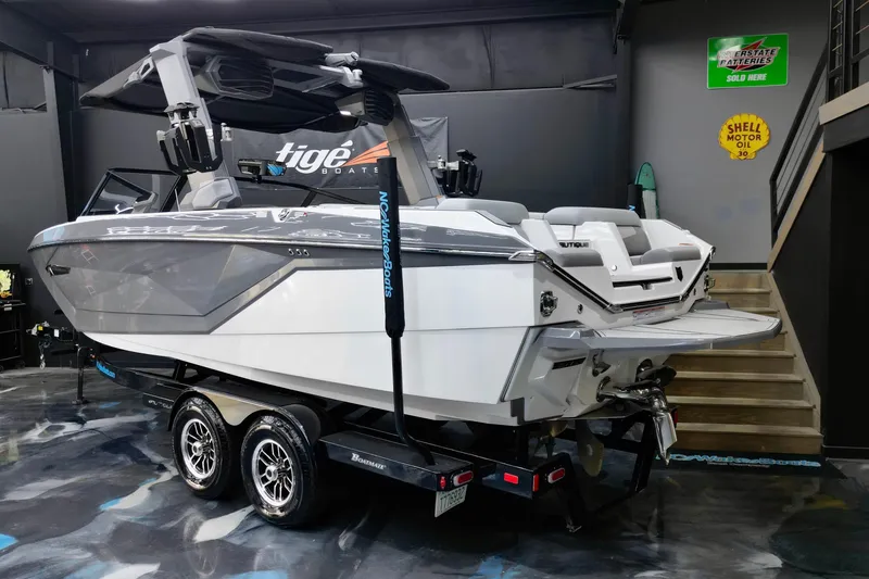 Slide: The Image of 2024 Nautique Super Air Nautique G23 boat on trailer in showroom. - 16