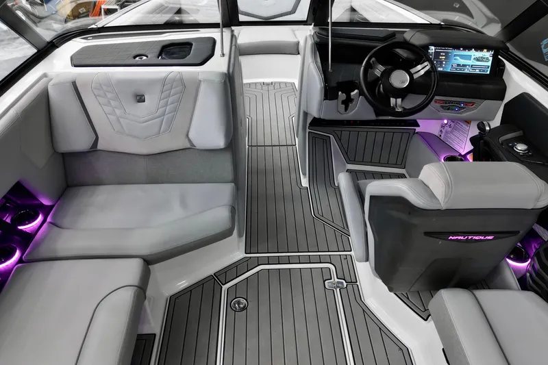 Slide: The Image of 2024 Nautique Super Air Nautique G23 interior with modern dashboard and ambient lighting. - 9