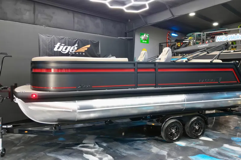 Slide: The Image of 2026 Viaggio Lago X-U 22 pontoon boat in showroom, sleek design with red accents. - 12