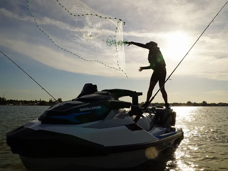 Slide: The Image of Angler casting net from Sea-Doo FishPro Sport 170 on lake. - 4