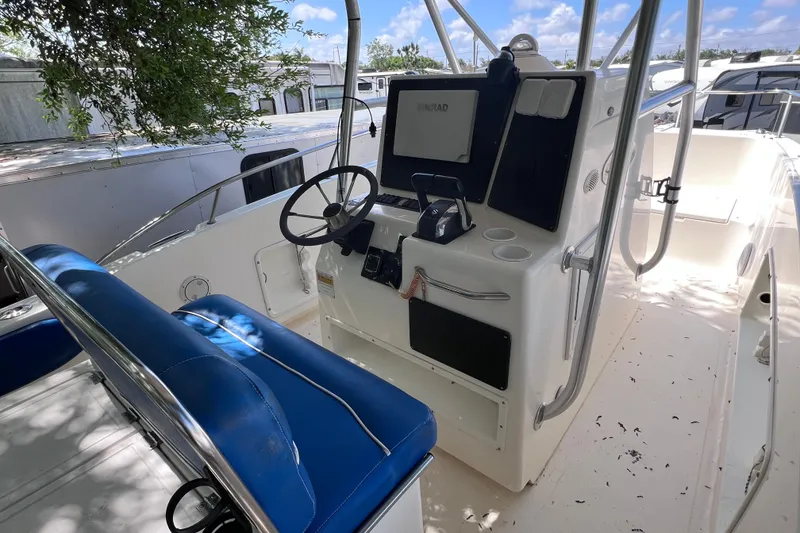 Slide: The Image of 1999 World Cat 246 SF boat cockpit with blue seating and steering console. - 11