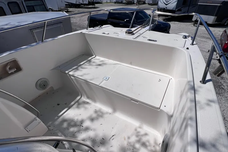 Slide: The Image of 1999 World Cat 246 SF boat interior with seating and storage compartments. - 12