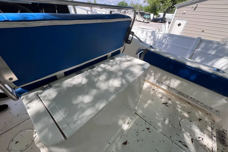 Slide: The Image of 1999 World Cat 246 SF boat interior with blue seating and storage compartment. - 18