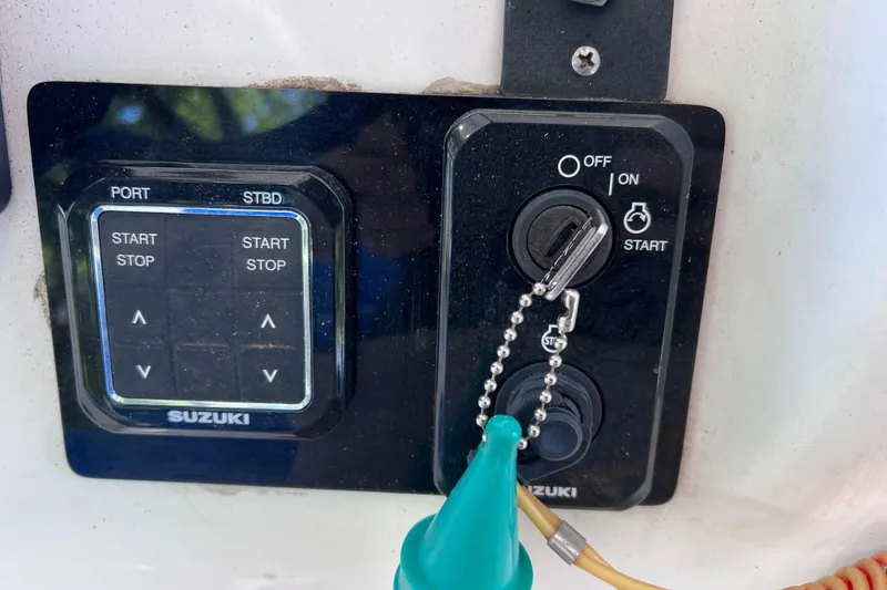 Slide: The Image of Control panel of a 1999 World Cat 246 SF boat with Suzuki ignition switches. - 26
