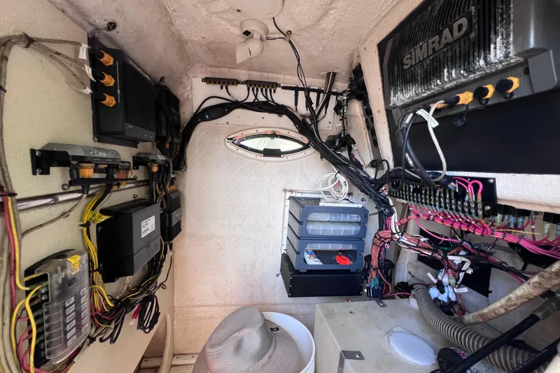 Slide: The Image of Interior of a 1999 World Cat 246 SF boat showing electronic wiring and equipment. - 29