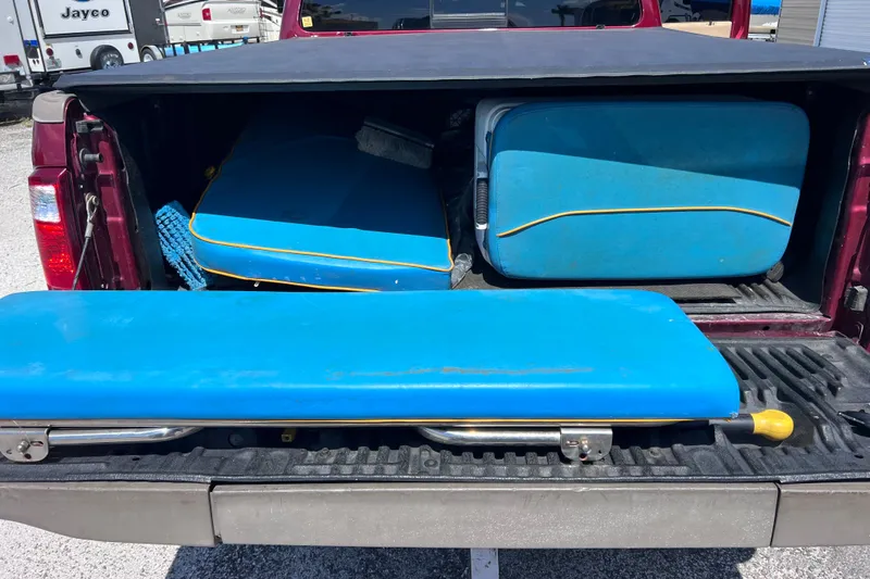 Slide: The Image of Truck bed with blue boat cushions from a 1999 World Cat 246 SF. - 31