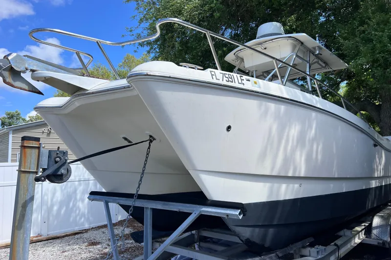 Slide: The Image of 1999 World Cat 246 SF boat on trailer, white hull, outdoor setting. - 4