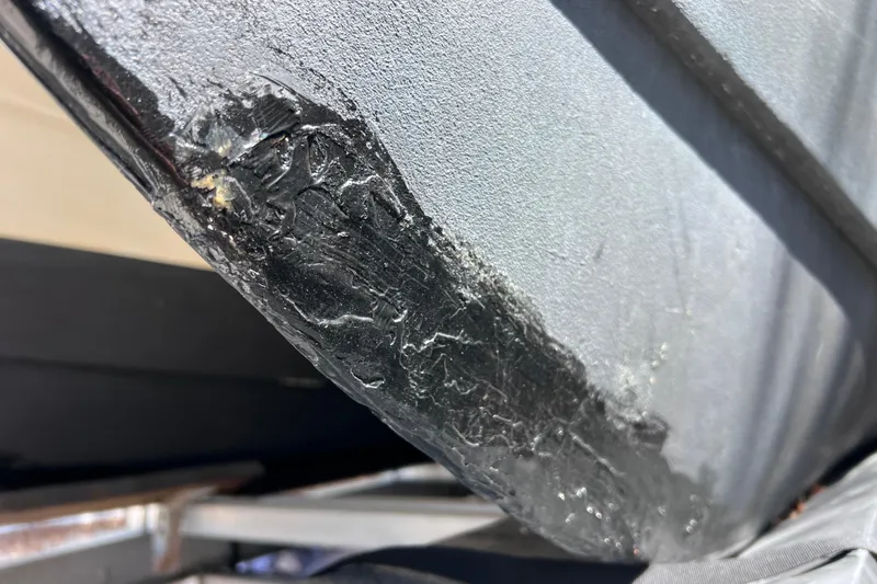 Slide: The Image of Close-up of a damaged hull on a 1999 World Cat 246 SF boat. - 43