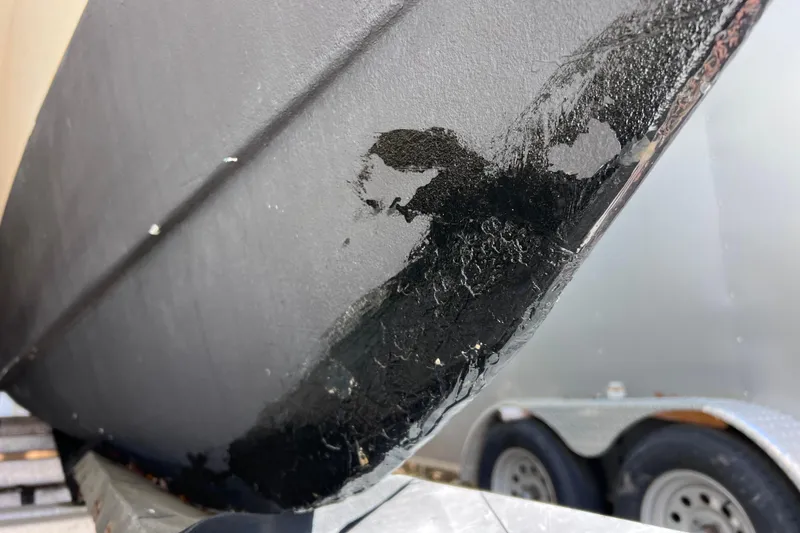 Slide: The Image of Close-up of damaged hull on 1999 World Cat 246 SF boat. - 46
