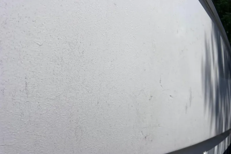 Slide: The Image of Close-up of a white surface on a 1999 World Cat 246 SF boat. - 48