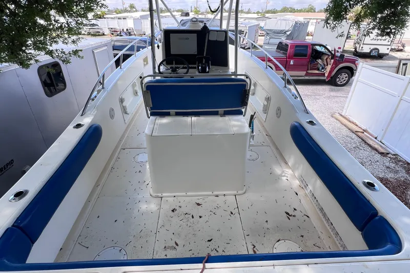 Slide: The Image of 1999 World Cat 246 SF boat interior with blue seating and steering console. - 9