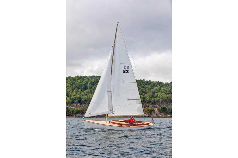 Slide: The Image of Sailboat Bridges Point BP 24, 1998 model, sailing on a lake with forested shoreline. - 1