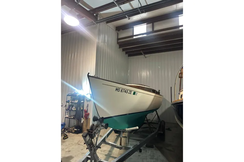 Slide: The Image of 1998 Bridges Point BP 24 sailboat on trailer in indoor storage facility. - 11