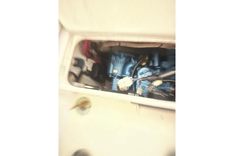 Slide: The Image of Engine compartment of a 1998 Bridges Point BP 24 boat, showing wiring and components. - 12
