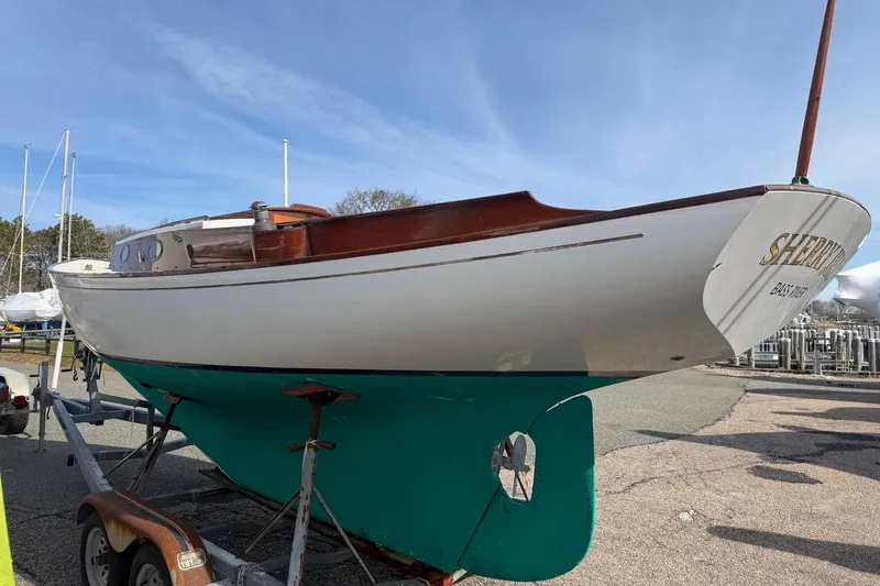 Slide: The Image of 1998 Bridges Point BP 24 sailboat on trailer, white hull, green keel, dockside setting. - 4