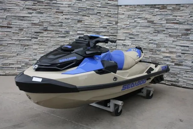 Slide: The Image of 2026 Sea-Doo Wake Pro 230 jet ski in blue and beige against stone wall. - 4