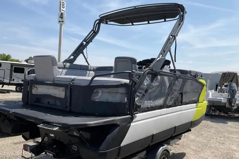 Slide: The Image of 2024 Sea-Doo Switch Cruise 18 pontoon boat on trailer, parked outdoors. - 6