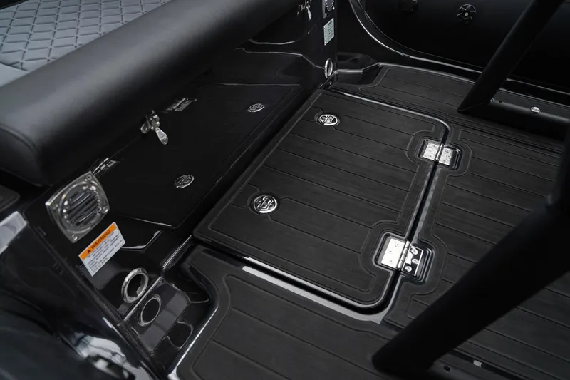 Slide: The Image of Interior of 2026 Brig Navigator 20 boat, featuring sleek black flooring and storage compartments. - 13