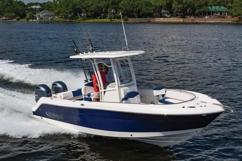 Slide: The Image of Manufacturer Provided Image: 2019 Robalo R242 Center Console boat cruising on a lake with two passengers. - 3